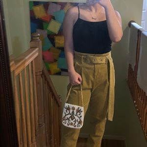 Yellow corduroy pants with belt buckle